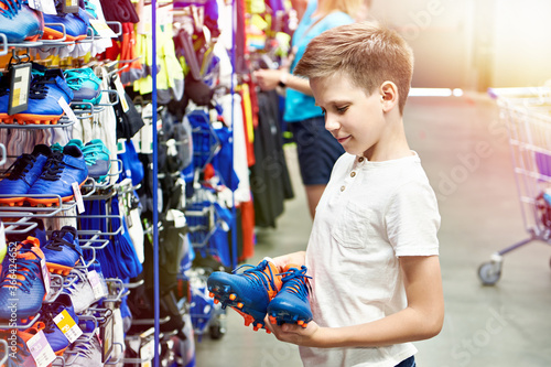Boy with boots in a football store