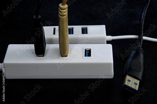 Universal serial bus conector hub and cable on black background photo