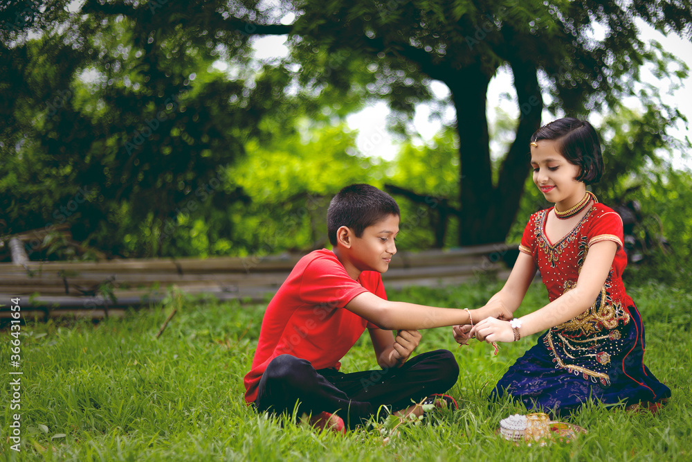Young indian brother and sister celebrating raksha bandhan festival at home Young indian brother and sister celebrating raksha bandhan festival at home