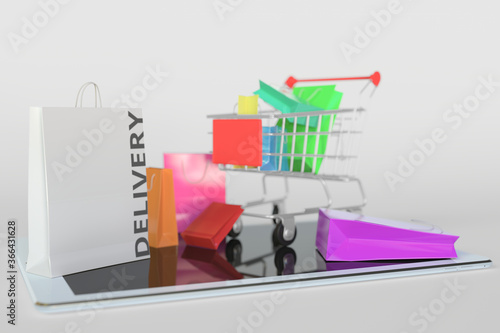 Shopping cart on a tablet computer and paper bag with DELIVERY text. E-commerce related 3D rendering photo