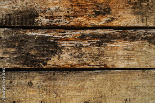 Very old decaying planks damaged by weathering