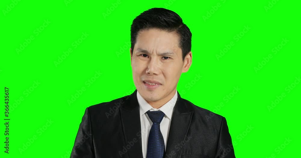 Businessman rise his hand mean not approve with serous face at green screen background. Businessman rise his hand mean not approve with serous face at green screen background.