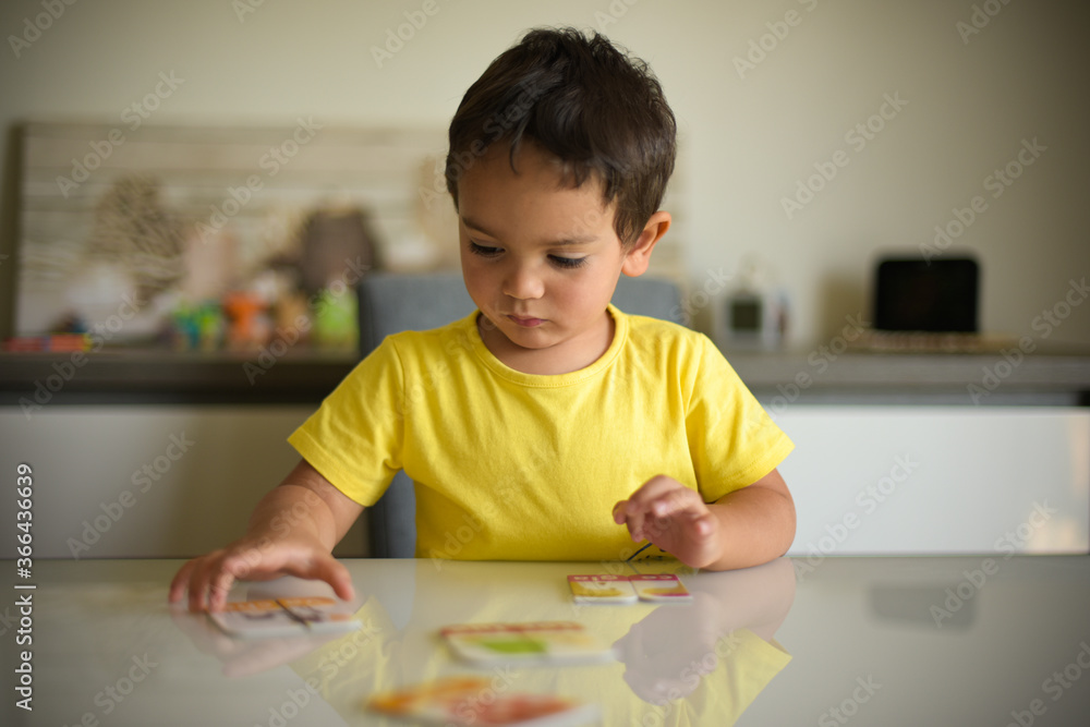 young boy playing at home with puzzle young boy playing at home with puzzle