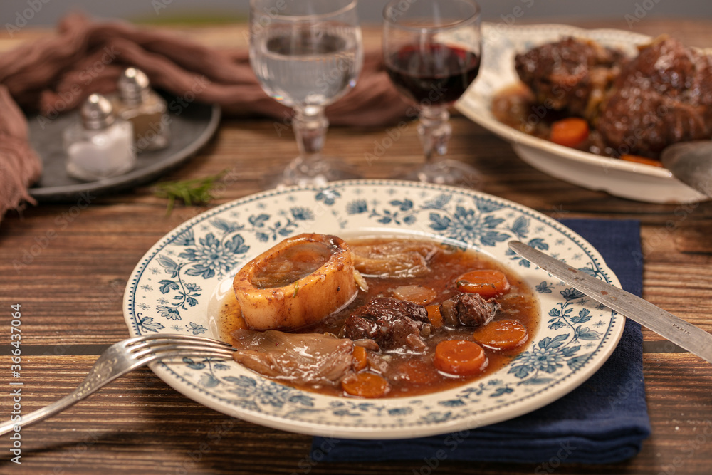Well-cooked beef shank in wine sauce served in an antique plate Well-cooked beef shank in wine sauce served in an antique plate