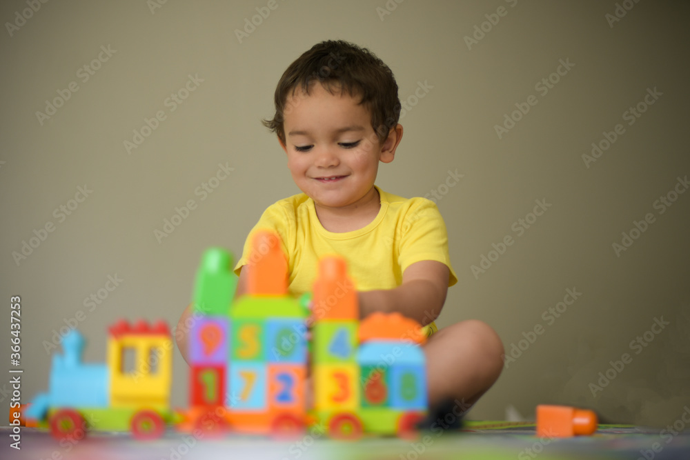 young boy playing home with blocks young boy playing home with blocks