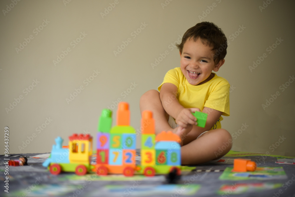 young boy playing home with blocks young boy playing home with blocks