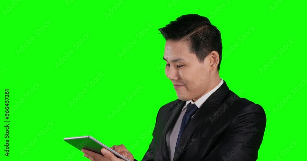 Portrait of businessman using smartphone with happy emotion at green screen background. Portrait of businessman using smartphone with happy emotion at green screen background.