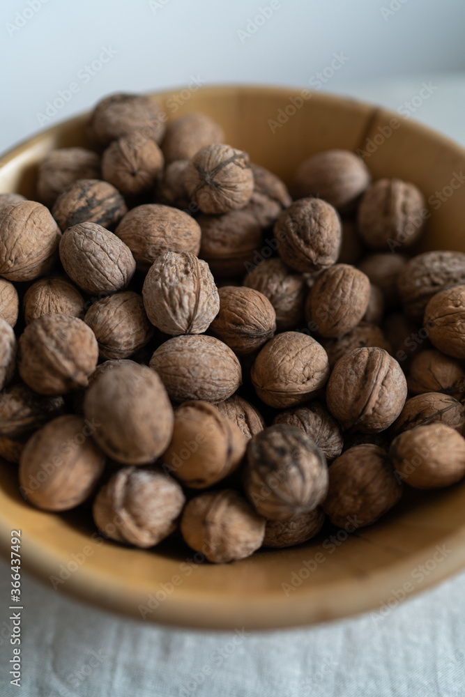 wooden bowl with walnuts in shells wooden bowl with walnuts in shells