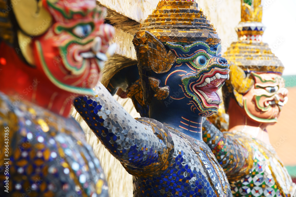 Naklejka premium colorful tradition demon statue which support golden pagoda