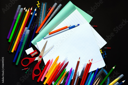 School supplies, office supplies on a black background. Flat lay style