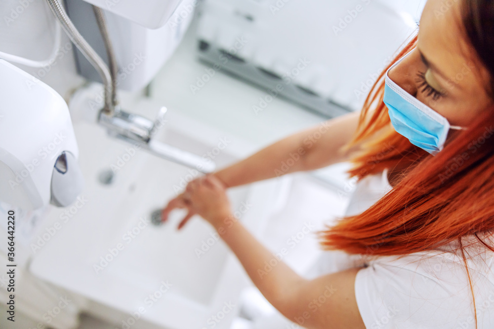 Closeup of lab assistant washing her hands while standing in laboratory. Closeup of lab assistant washing her hands while standing in laboratory.