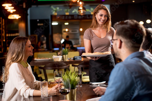 Waiter woman serving group ...