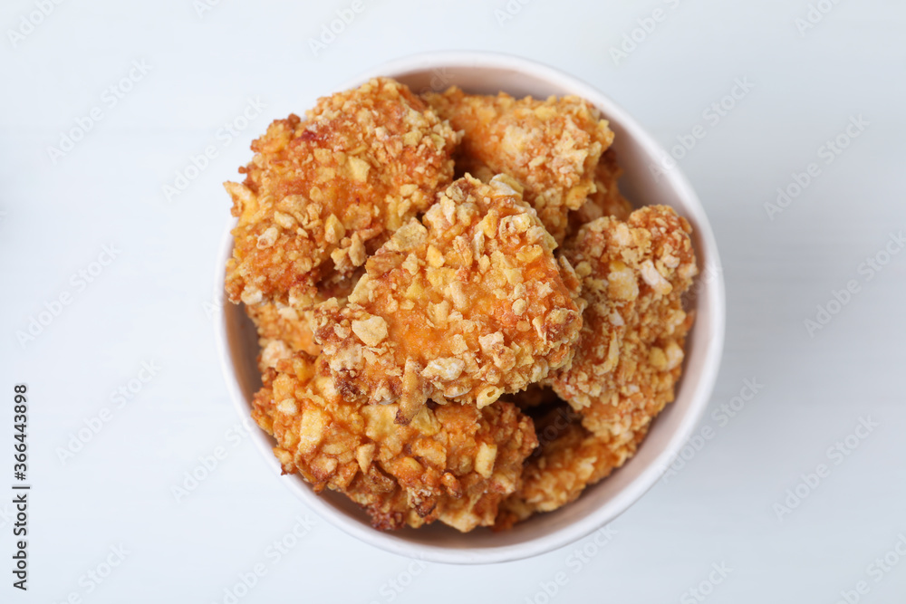 Bucket with yummy nuggets on white wooden table, top view Bucket with yummy nuggets on white wooden table, top view