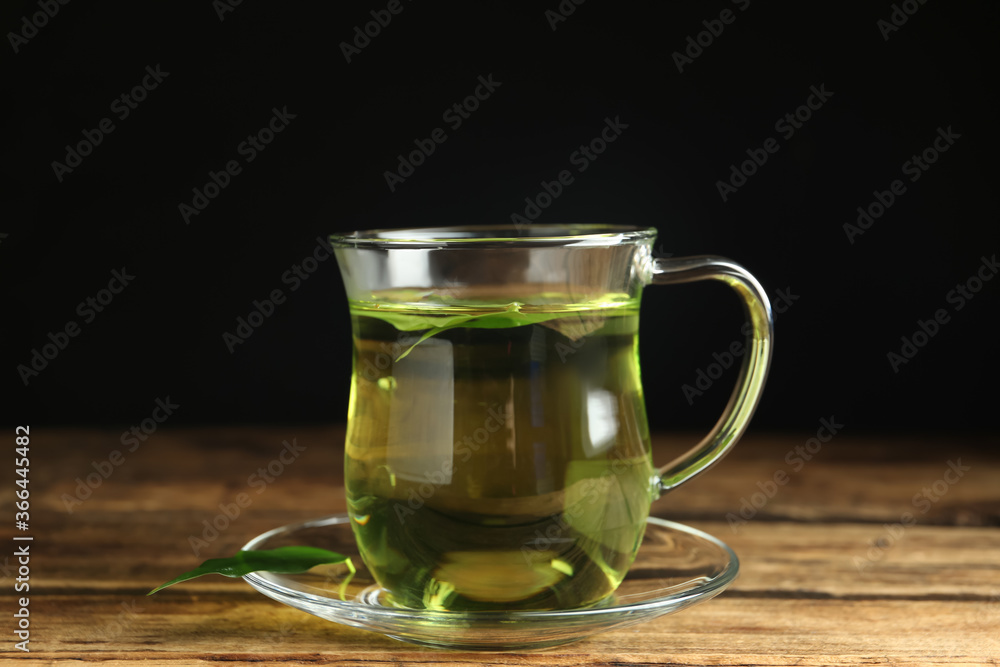 Cup of aromatic green tea on wooden table Cup of aromatic green tea on wooden table