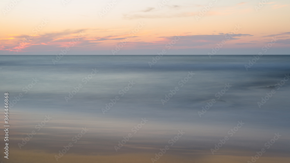 Beautiful blurry sunset at the sea on a hot, summer evening.