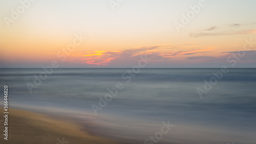 Beautiful blurry sunset at the sea on a hot, summer evening.