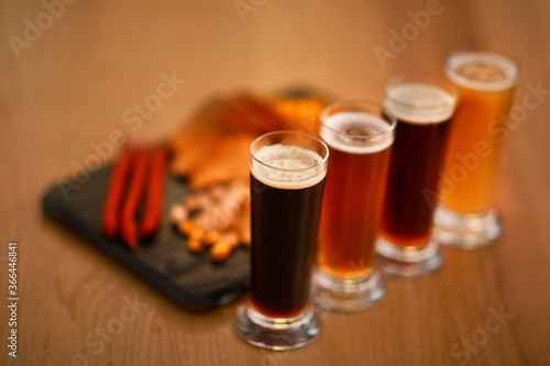 Beer tasting set served with snacks on wooden table