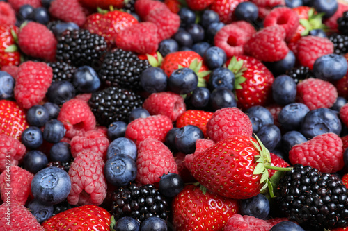 Mix of different ripe tasty berries as background, closeup view