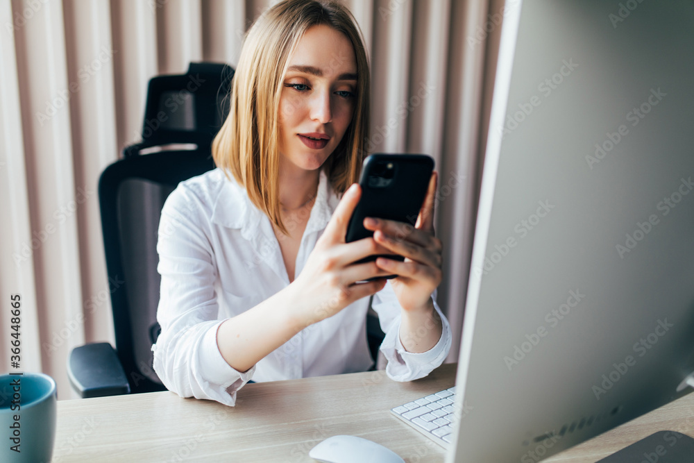 Young business woman with phone working on desk documents and laptop Young business woman with phone working on desk documents and laptop