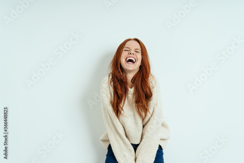 Happy young woman enjoying a good laugh