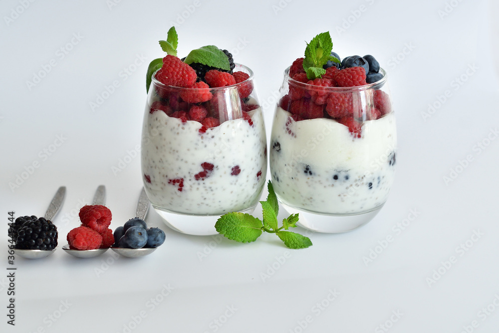two glasses of delicious homemade smoothie, dessert made from chia and berries. delicious milkshake, vegan raw food. Healthy food and breakfast. Good morning.Selective focus two glasses of delicious homemade smoothie, dessert made from chia and berries. delicious milkshake, vegan raw food. Healthy food and breakfast. Good morning.Selective focus