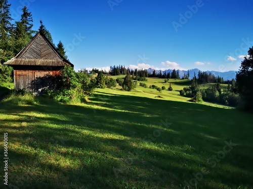 Podhale Poland. An old highlander shed in the background of the Tatra Mountains.