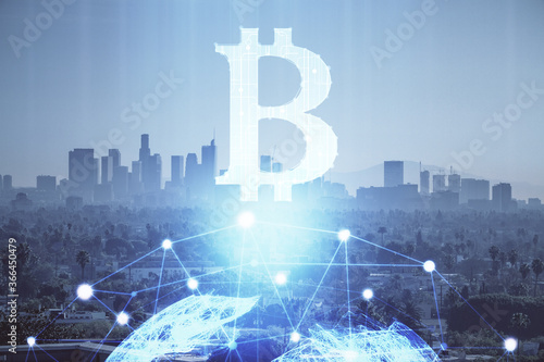 Double exposure of crypto currency theme hologram drawing and city veiw background. Concept of blockchain and bitcoin.