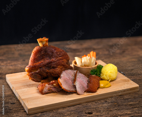 Roast pork leg on a wooden board,Deep fried pork knuckle or German Pork Hocks on wood board photo