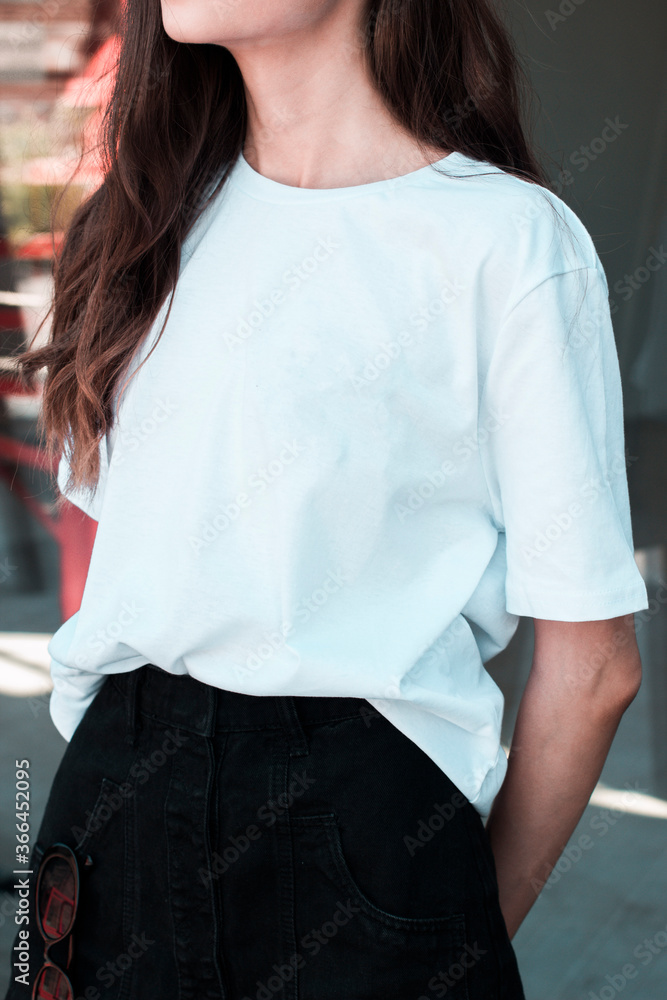 A young woman in a white t-shirt. For a clothing brand. Mock up. A young woman in a white t-shirt. For a clothing brand. Mock up.