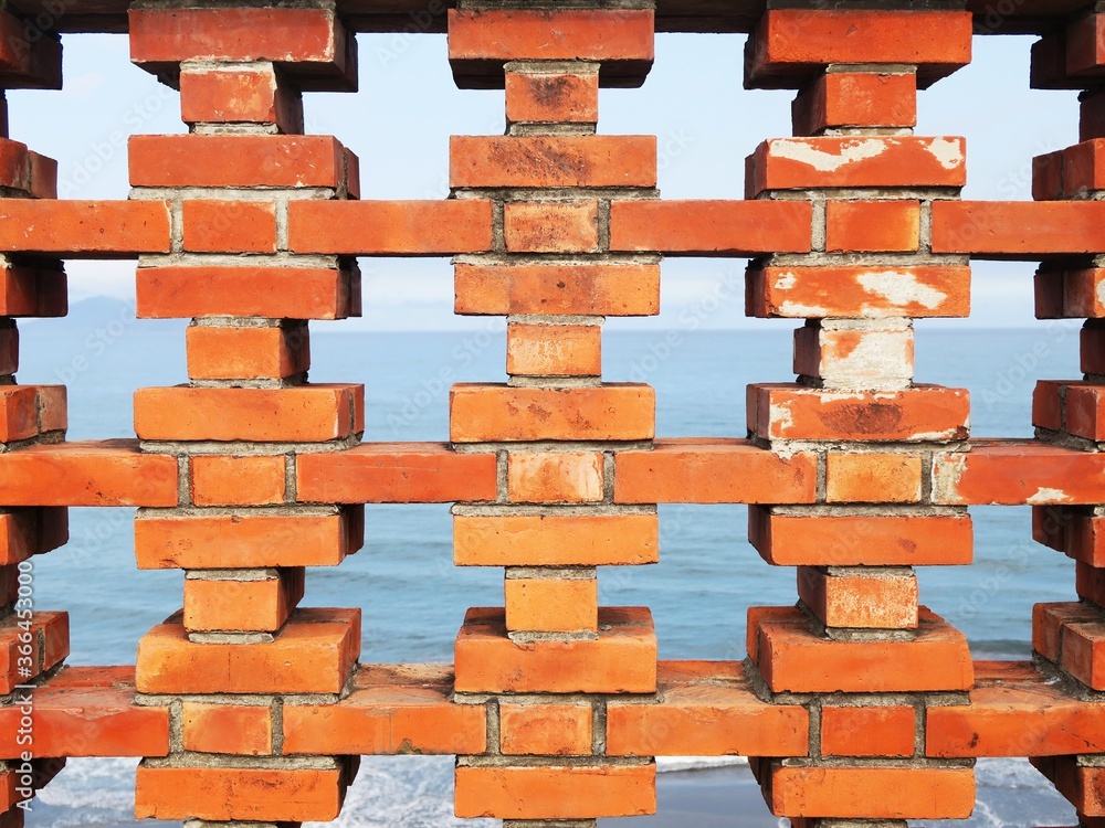 Obraz premium Orange red brick pattern in a watching tower near the sea