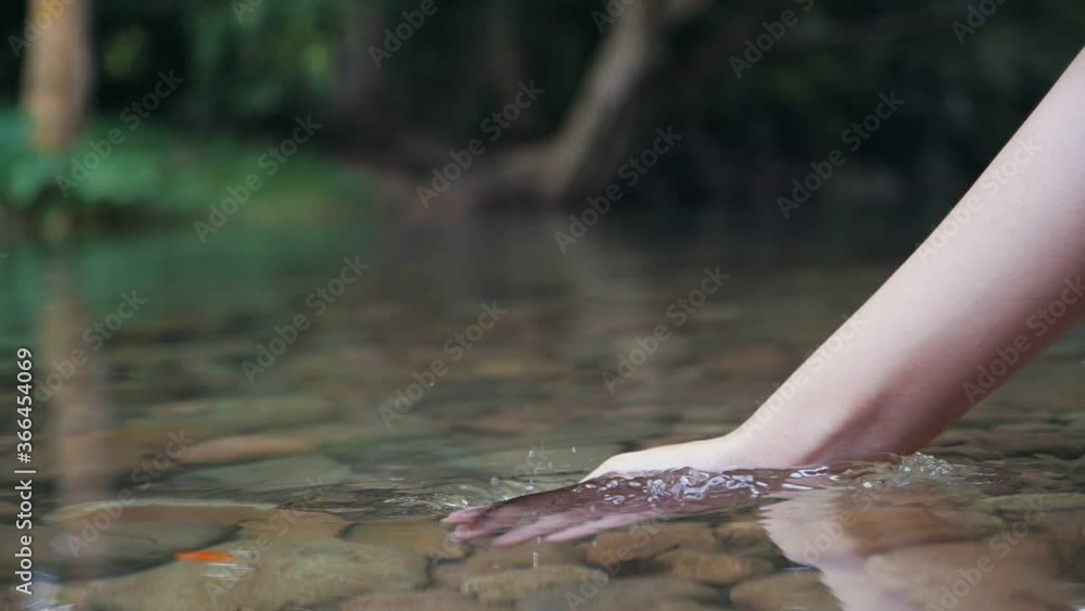 Hand scooping fresh water in the forest river or lake, Close up of holding pure water in cupped hand in Slow Motion. Hand scooping fresh water in the forest river or lake, Close up of holding pure water in cupped hand in Slow Motion.