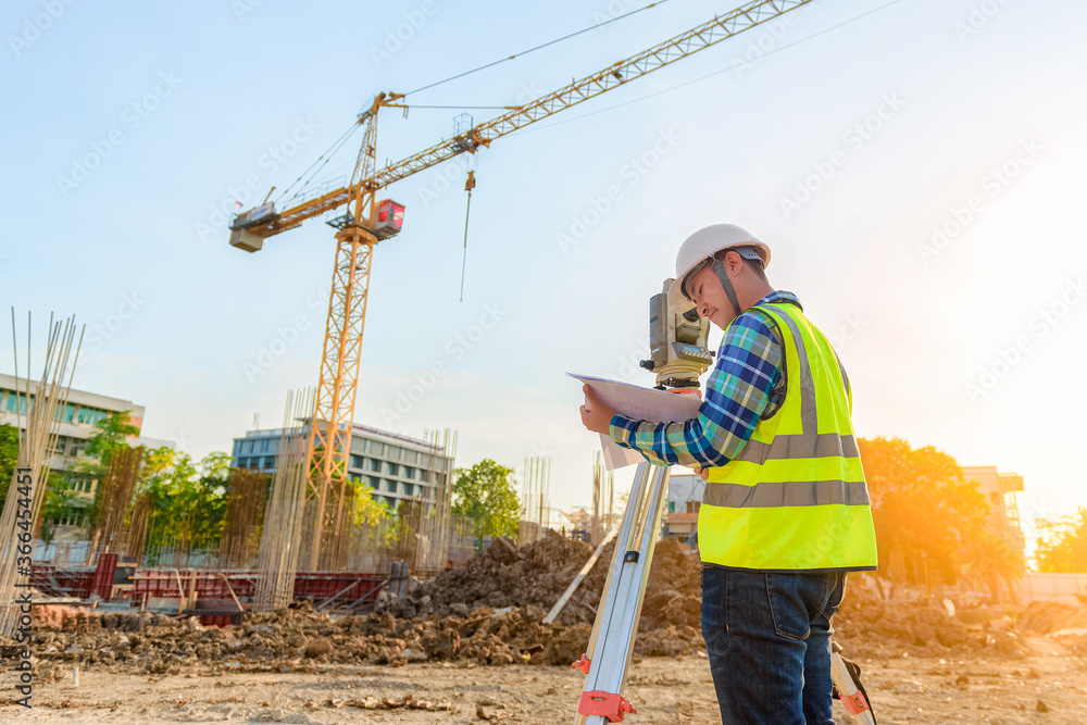 Surveying engineers are working together using theodolite on the construction site. Surveying engineers are working together using theodolite on the construction site.