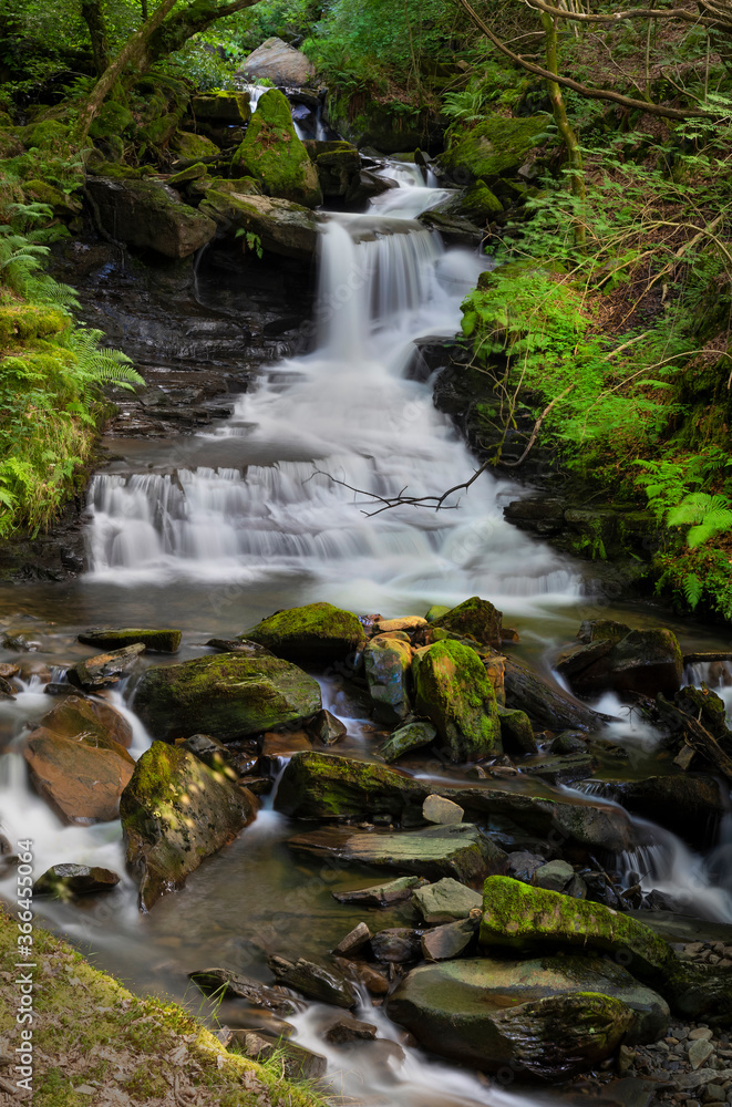Obraz premium The main waterfall on the river at Melincourt Brook in Resolven, South Wales, UK