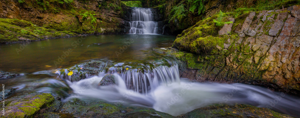 Fototapeta premium A panoramic of The Sychryd Cascades, (Sgydau Sychryd in Welsh) a set of waterfalls in the area called waterfall country near the Dinas Rock, Pontneddfechan, South Wales, UK