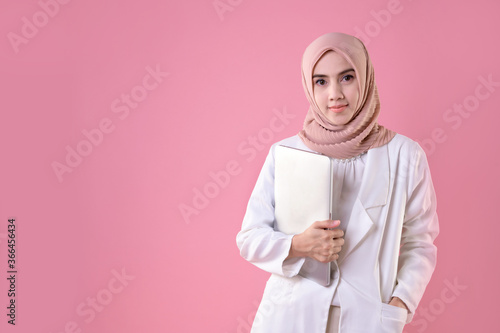 Portrait of happy young muslim business woman. Smiling pretty girl holding a digital tablet computer. Modern technologies and business
