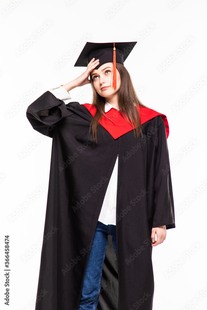 Graduating student girl in an academic gown isolated over white background. Graduating student girl in an academic gown isolated over white background.