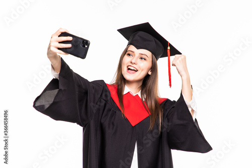 Young female graduated student taking selfie isolated on white background