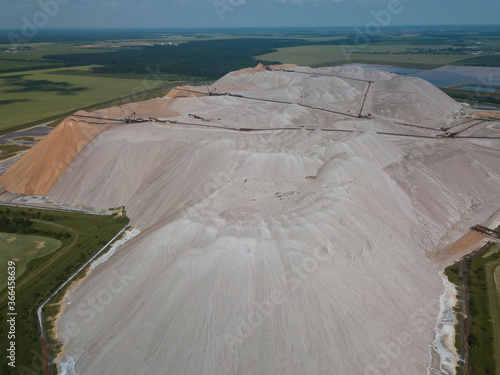 Huge mountains of waste rock dumps during the extraction of potash. Potash fertilizer production plant photo