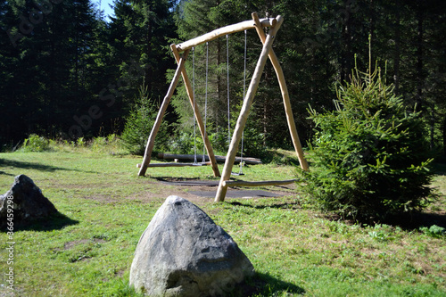 wooden swing in the forest