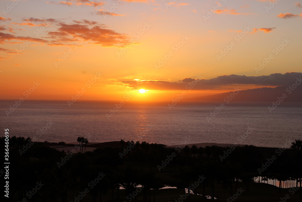 View of the Atlantic ocean, orange sunset and La Gomera Islands.