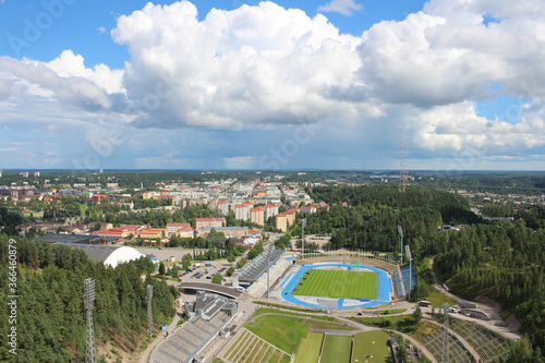 View of the stadium, forest and city of Lahti against the sky with clouds. Finland.