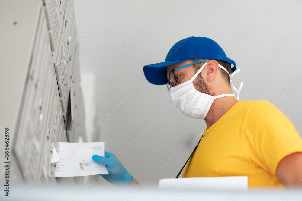 Mailman delivering mail with mail-bag and protective mask and gloves during virus pandemic. Mailman delivering mail with mail-bag and protective mask and gloves during virus pandemic.