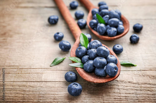 Wooden spoons with fresh ripe blueberries