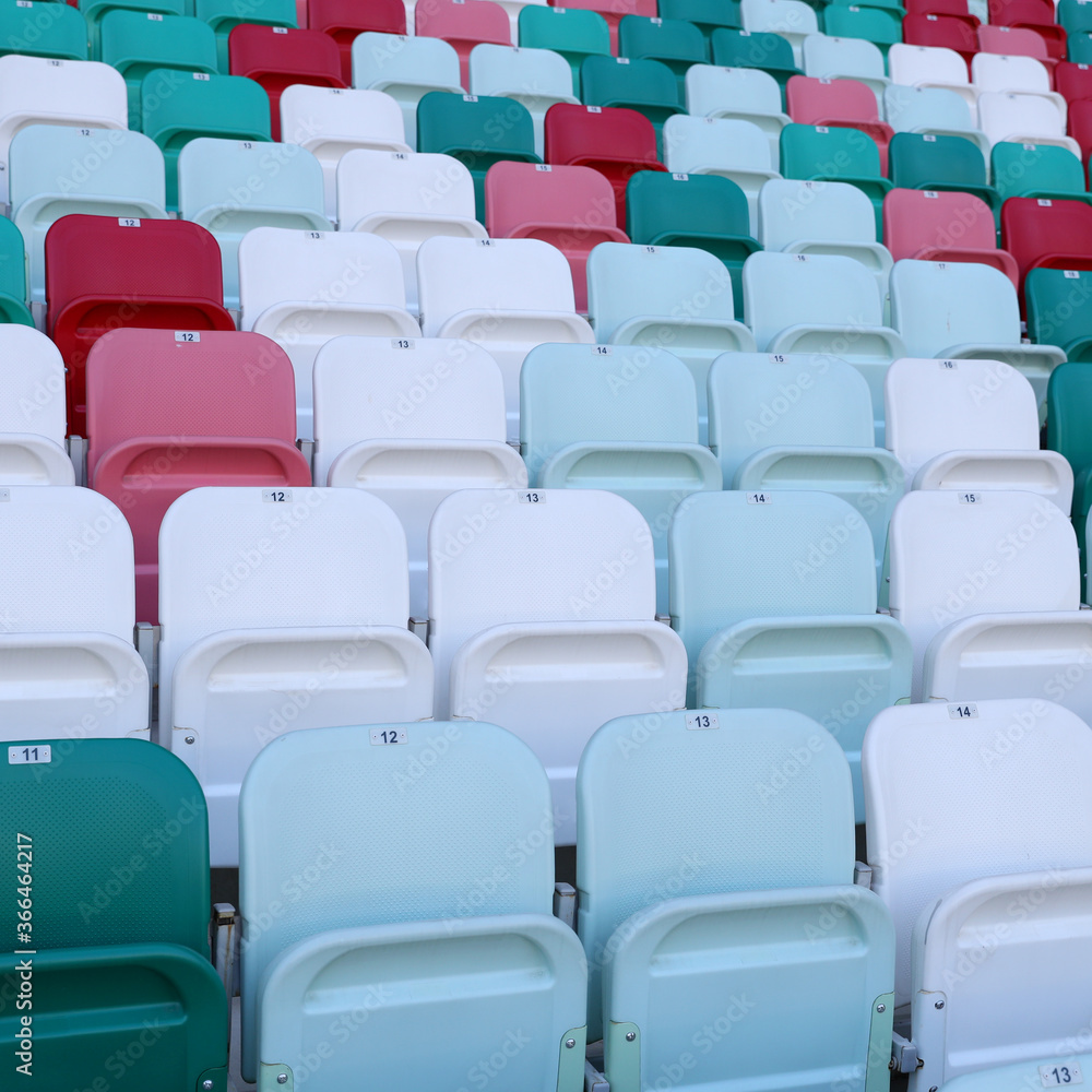 Naklejka premium Multicolored seats in a sports stadium. The seats for the fans