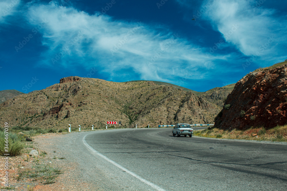 the car is driving on an asphalt road the car is driving on an asphalt road
