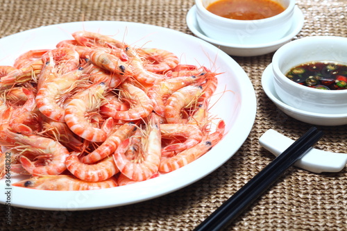 A Plate Of Steamed Shrimp With Two Sauce