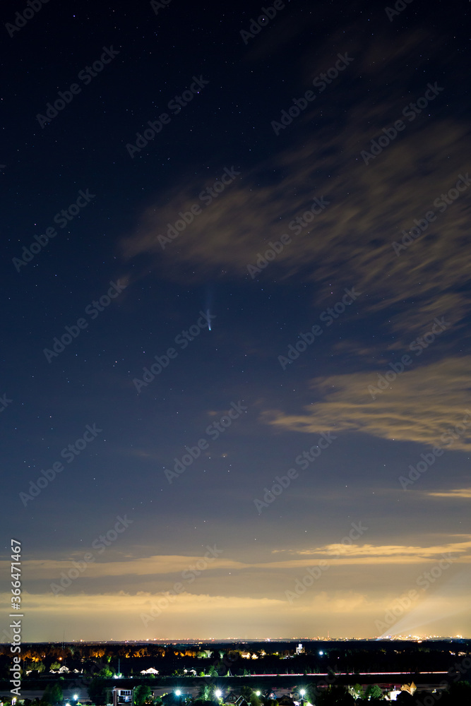 Fototapeta premium Comet neowise C2020 F3 in the night starry sky over the city and church