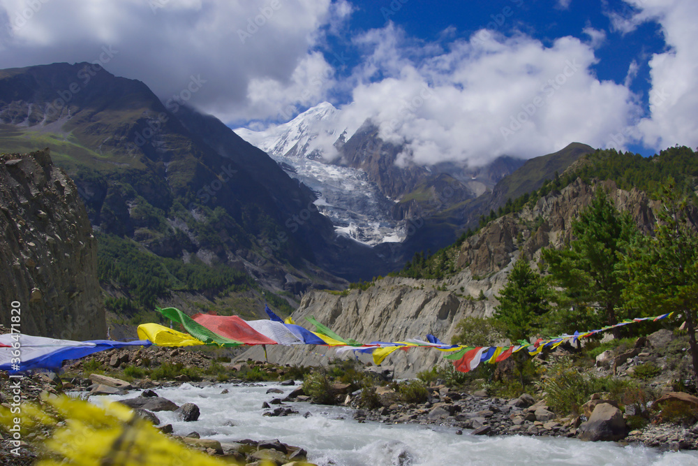 Gangapurna from upper Manang with Marsyangdi and prayer flags in the foreground. Acclimatization walk on the Annapurna circuit.