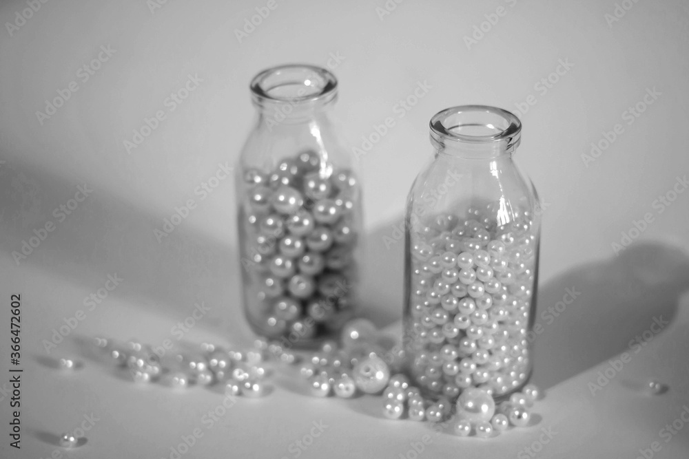 Glass bottle with pearl beads, black and white. Glass bottle with pearl beads, black and white.