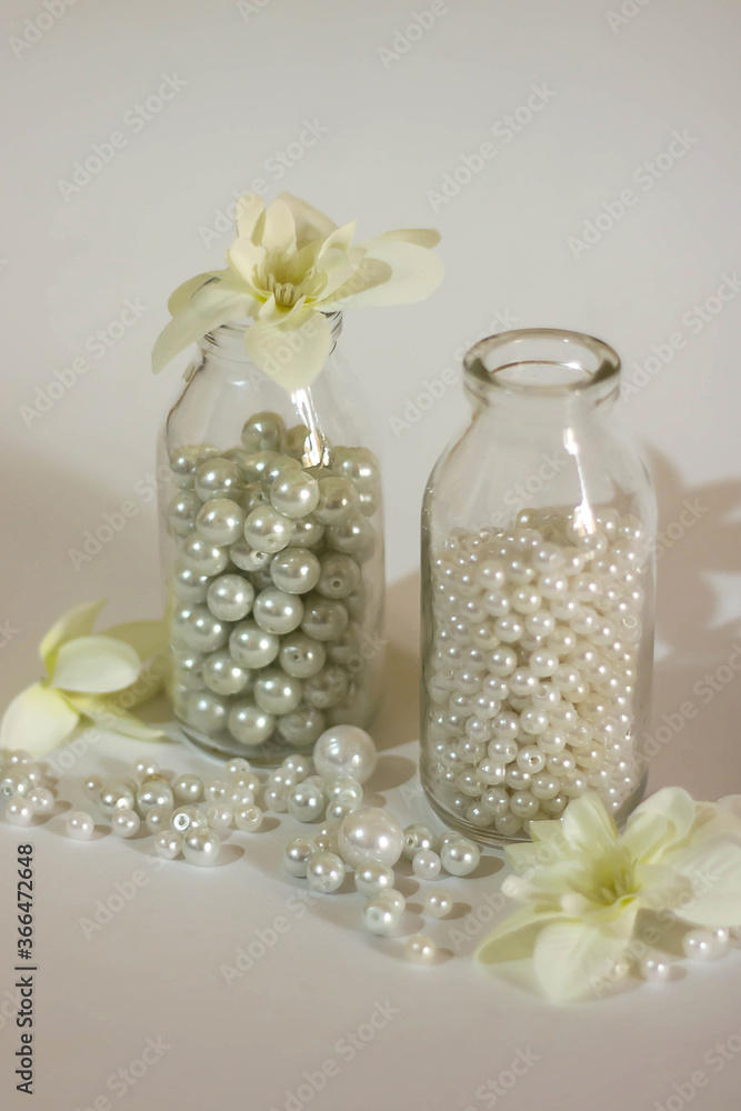 White pearl beads in glass bottles. White pearl beads in glass bottles.